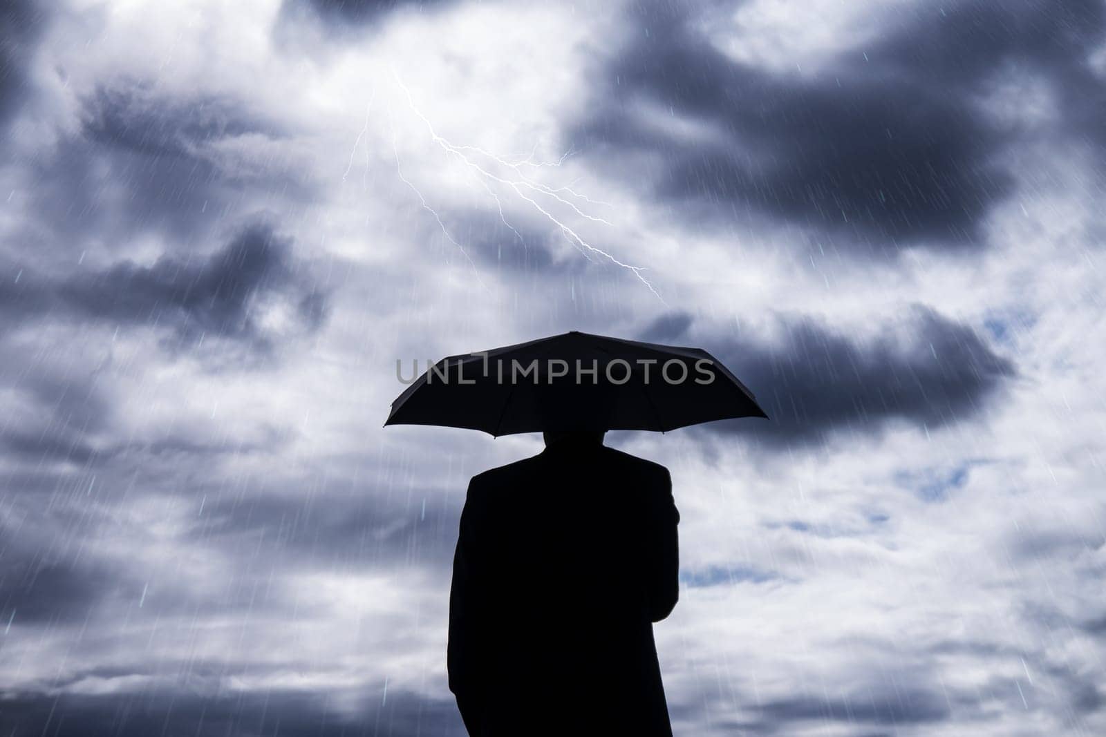 business man and umbrella in storm