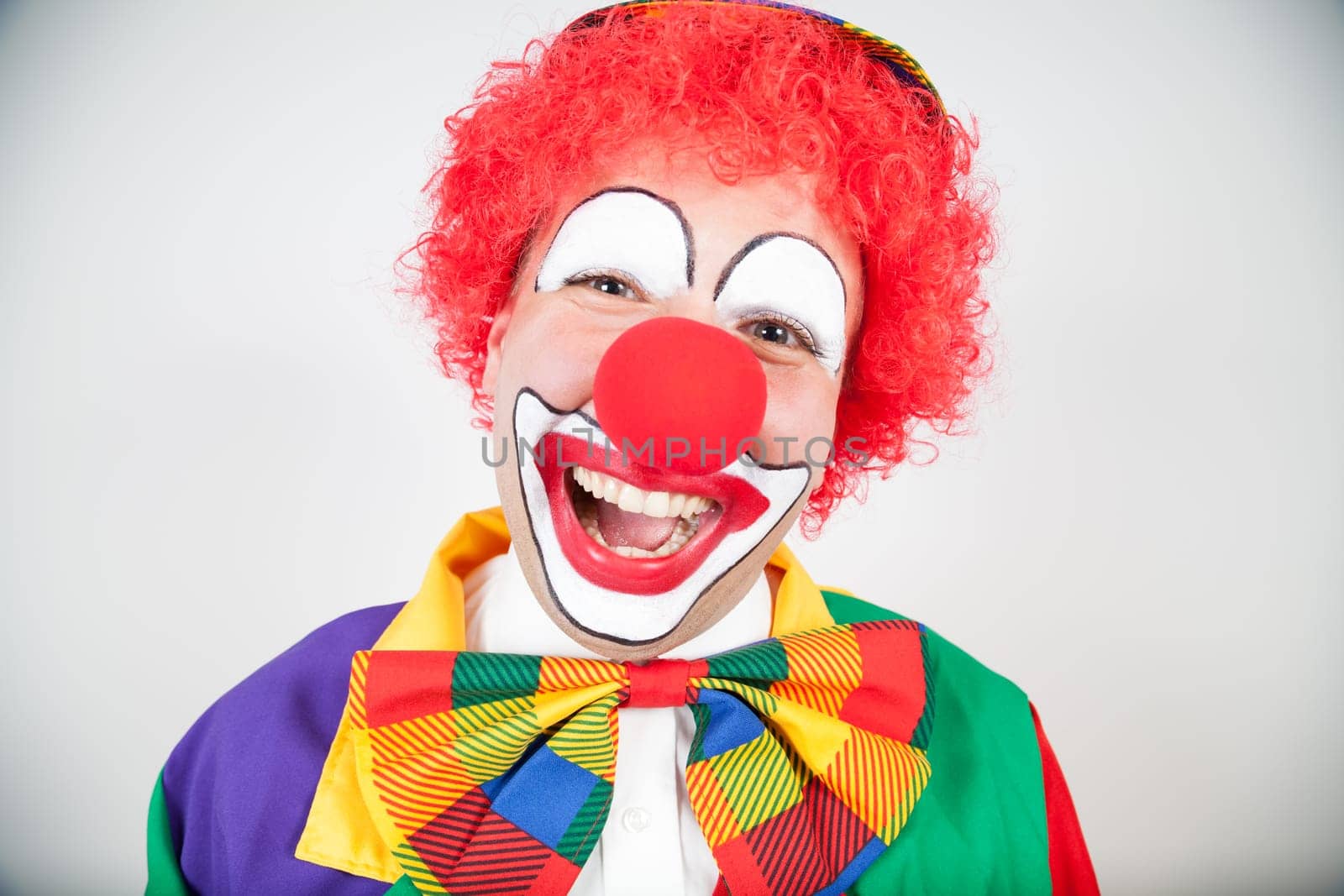 smiling clown with red hair on white