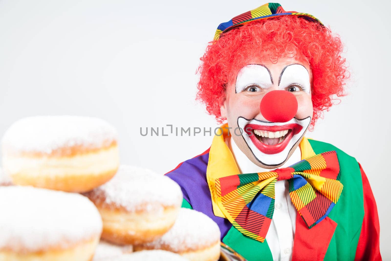 clown with pancakes on white