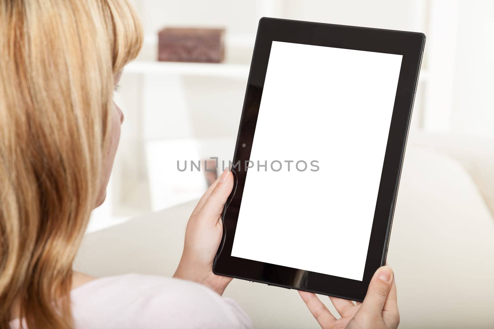 woman with tablet sitting on sofa
