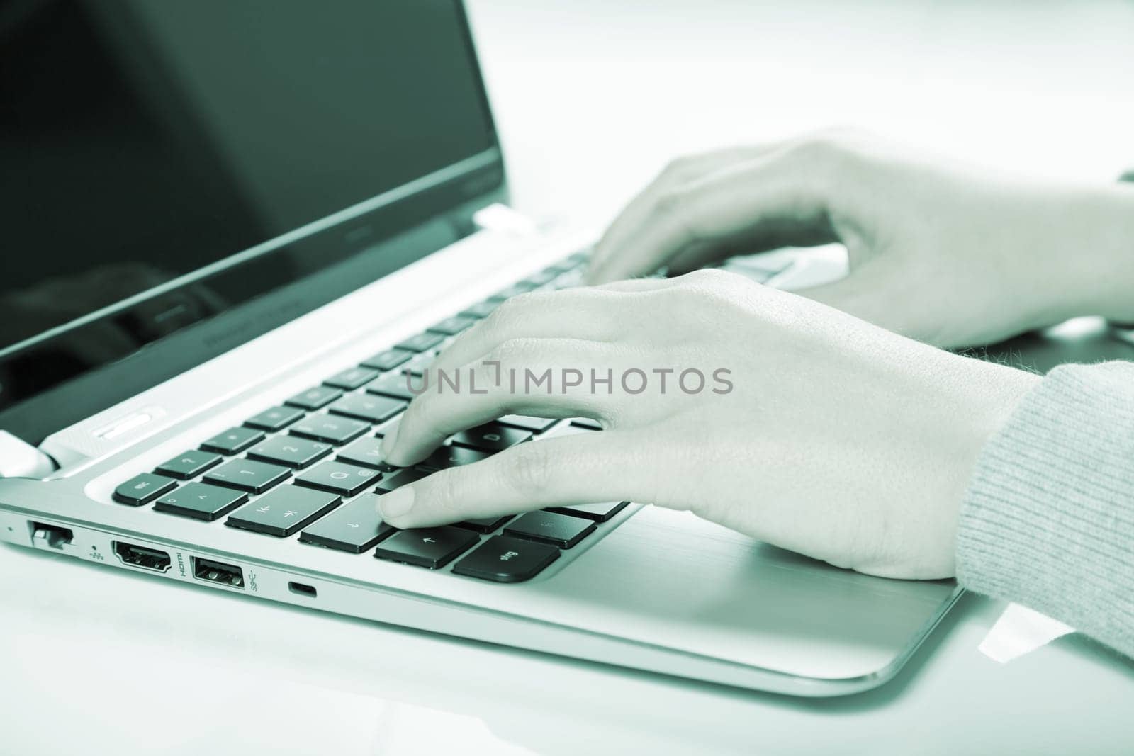 woman using laptop in green color