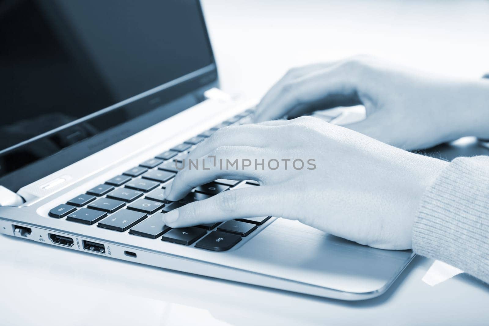 woman using laptop in blue color