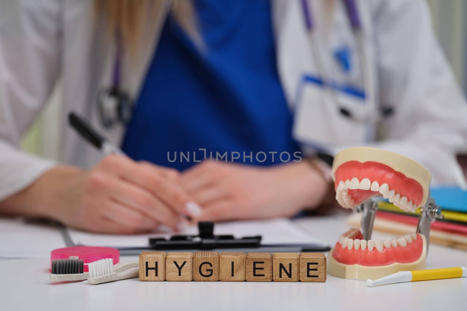 A dental expert highlights hygienes importance using specialized tools and models during patient consultations