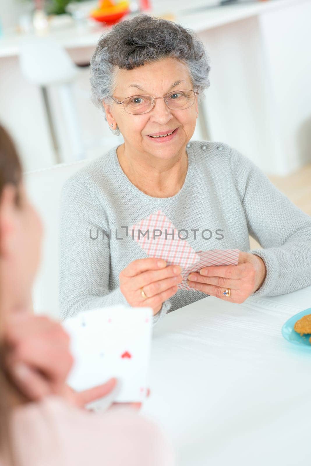 Old lady playing a card game