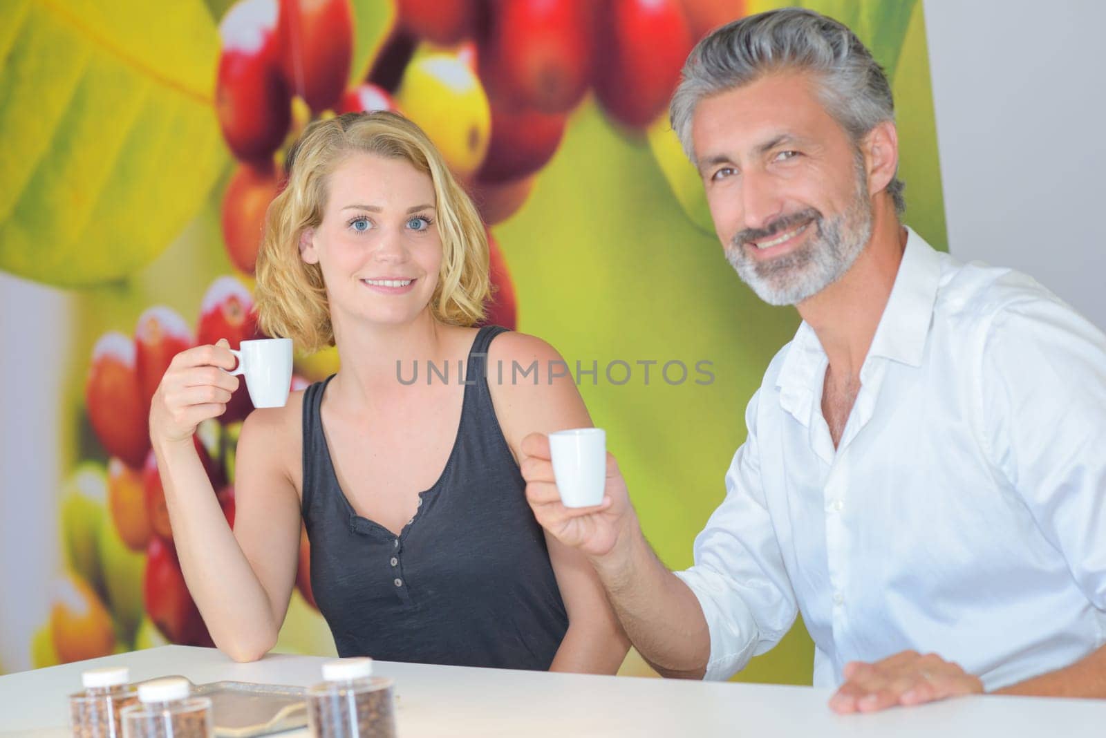 Portrait of man and woman holding coffee cups