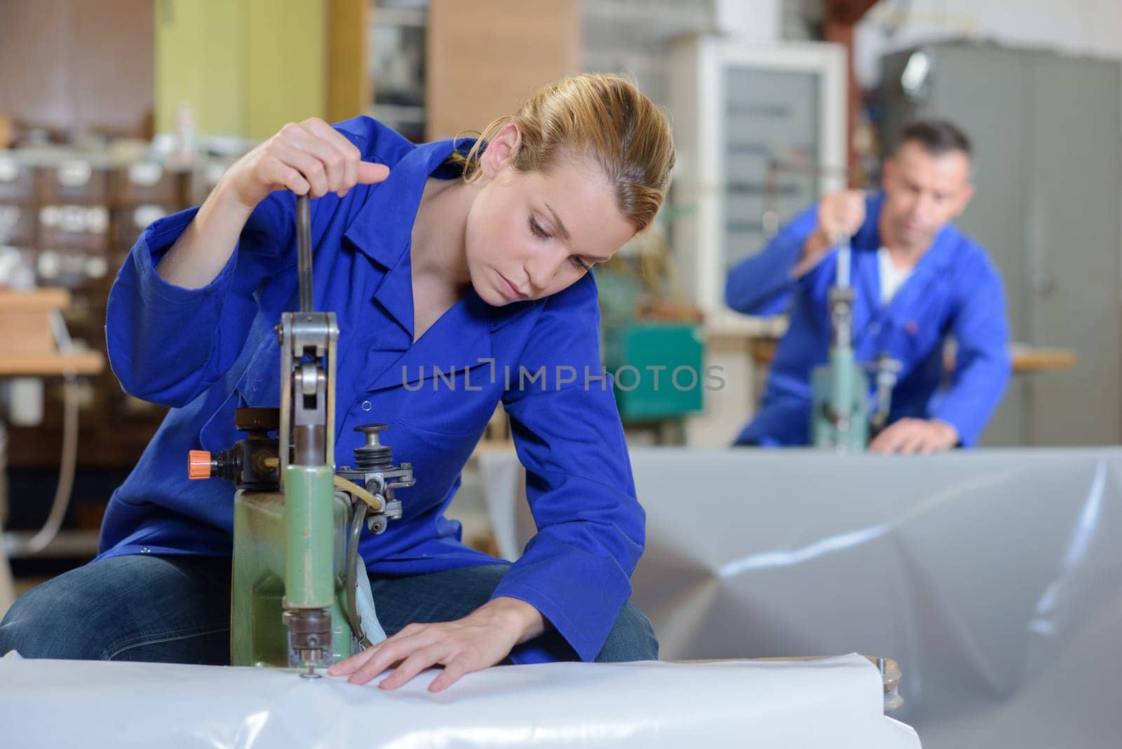 Woman sewing through plastic sheeting