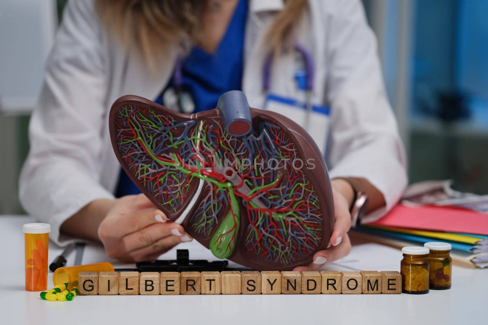 A medical expert explains Gilbert syndrome with a liver model and the medication needed for management