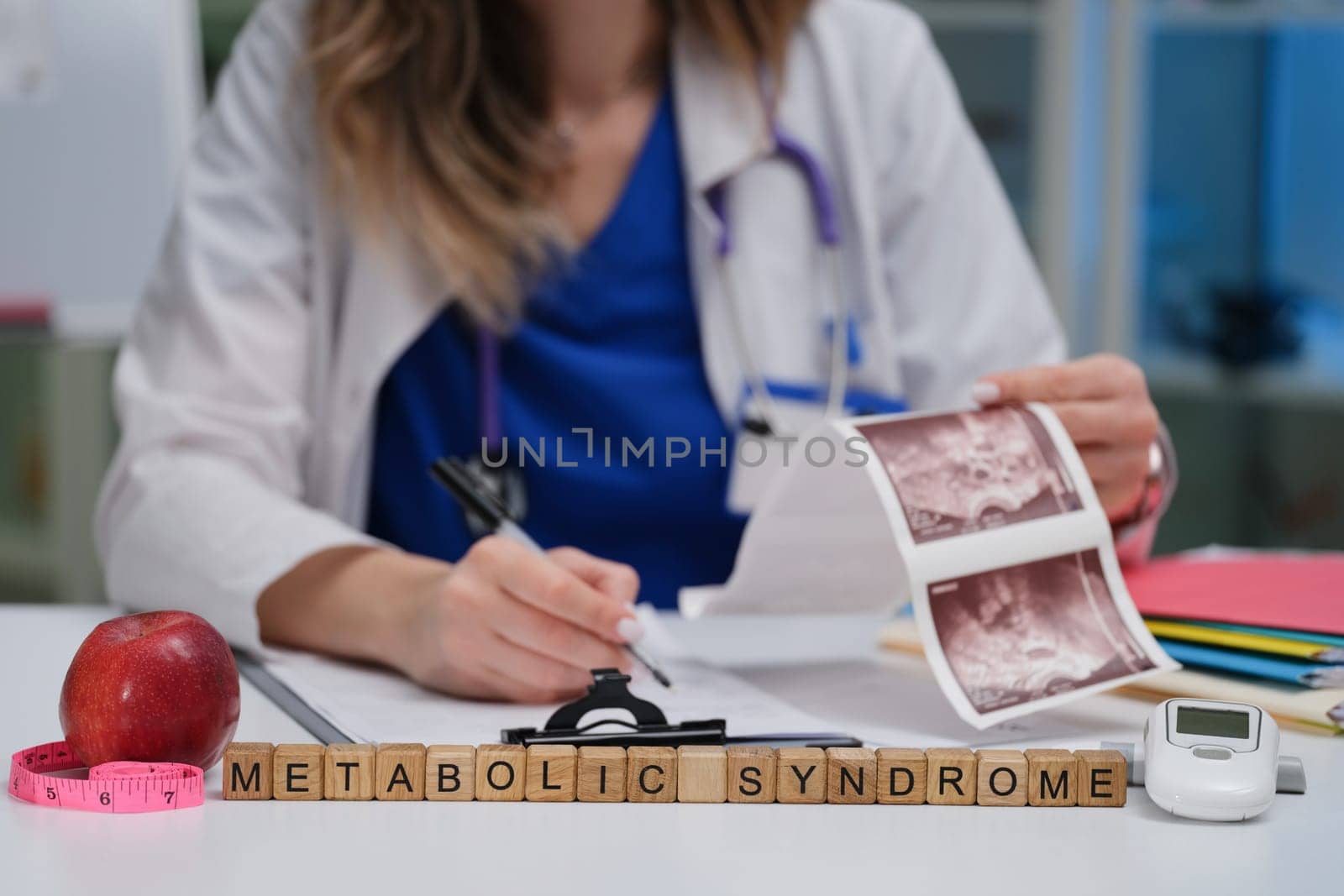 A healthcare professional examines metabolic syndrome using visual aids and tools for better understanding