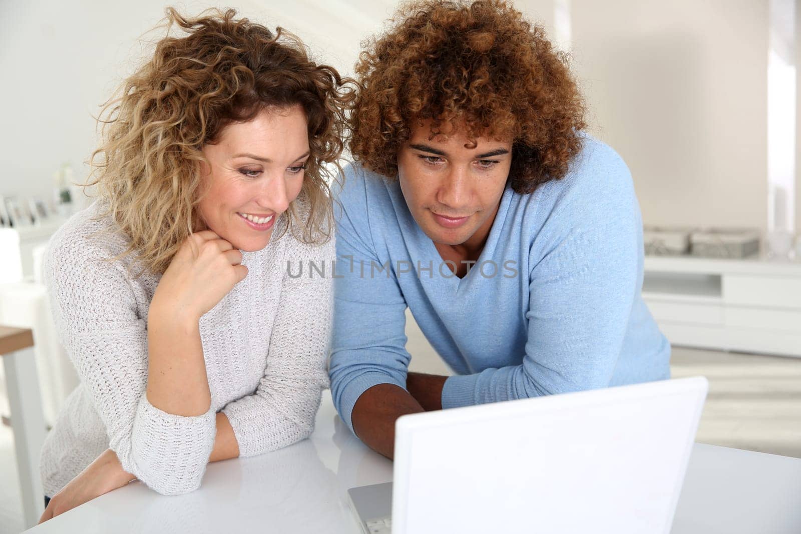 Couple websurfing on laptop computer