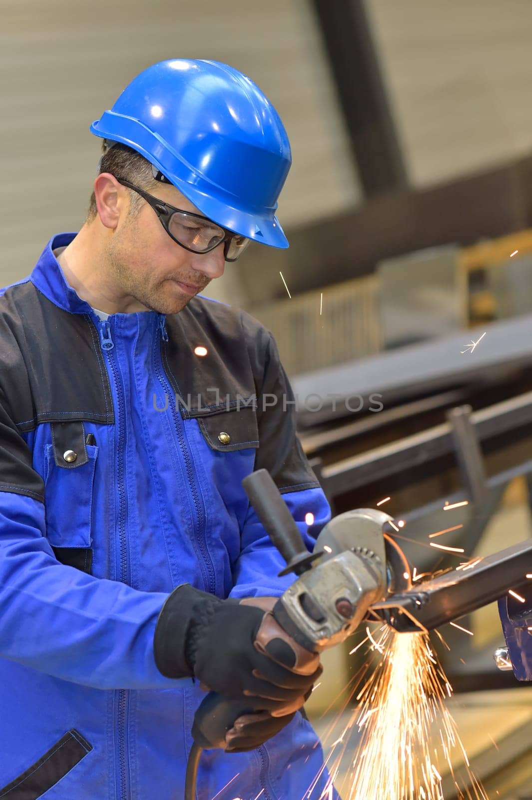 Man in factory working on metal