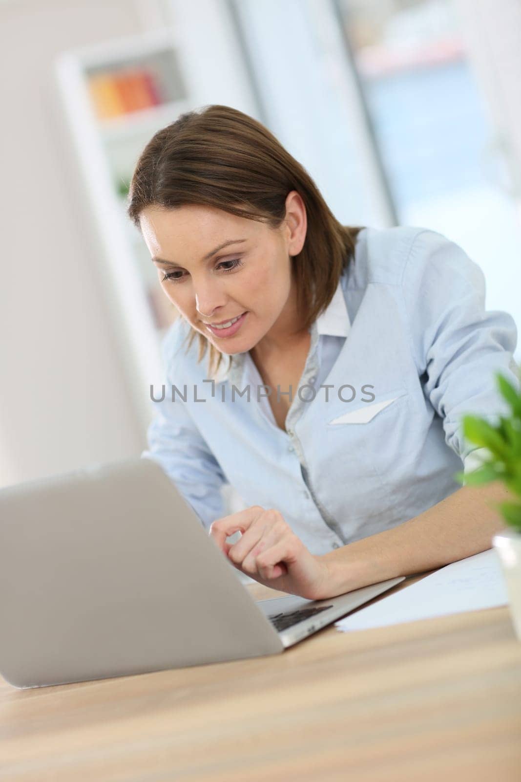 Woman in office working on laptop computer