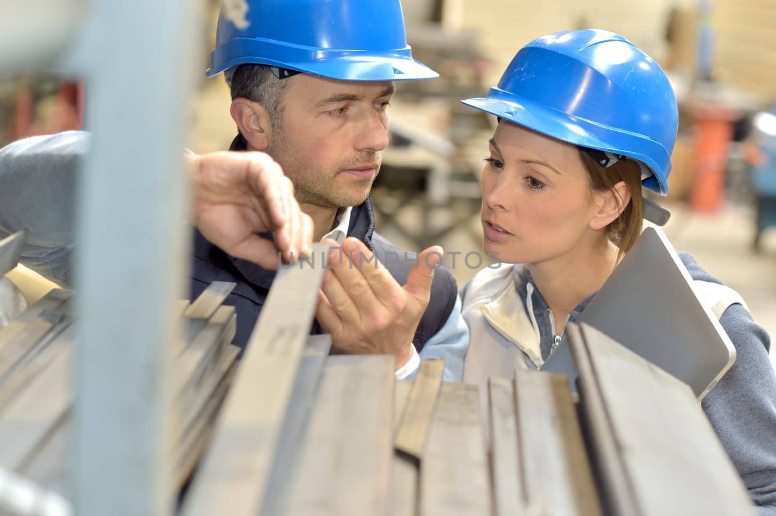 Supplier with engineer checking on production in factory