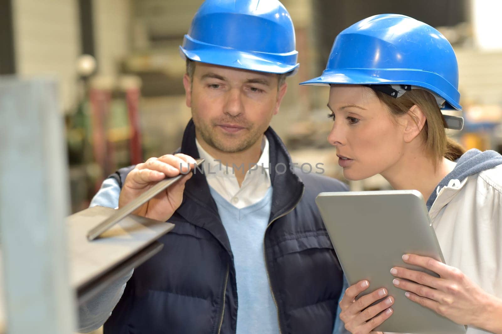 Supplier with engineer checking on production in factory