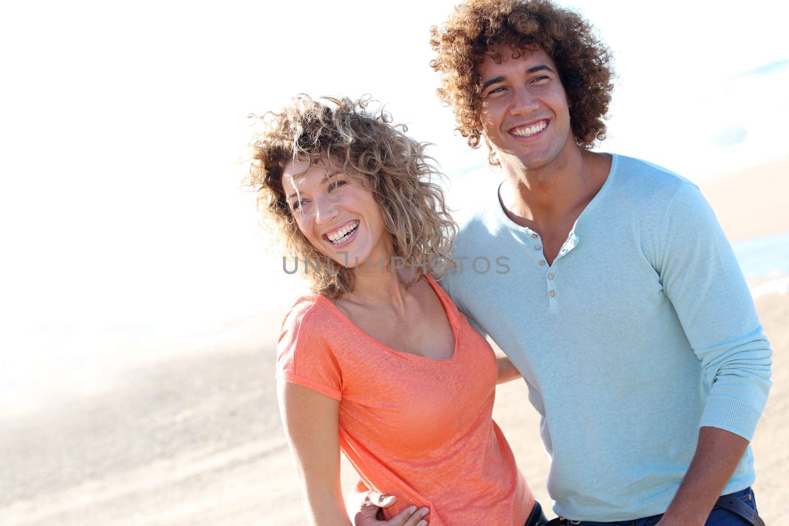 Smiling couple walking on the beach
