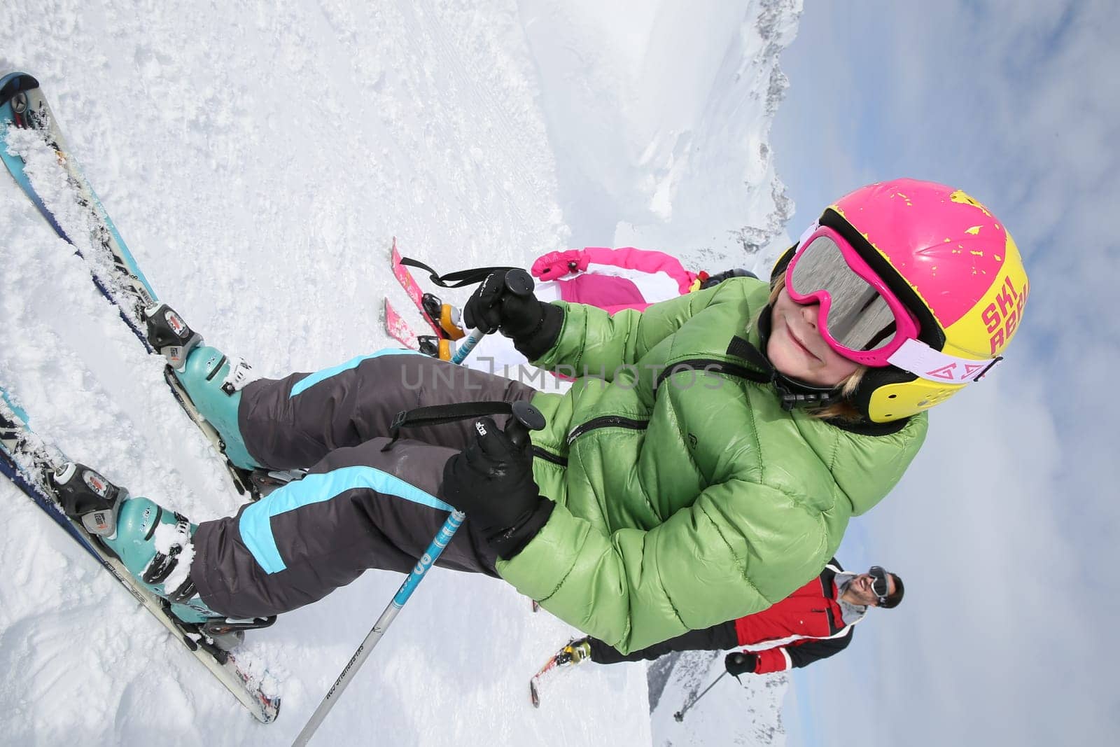 6-year-old boy skiing down ski slope with family