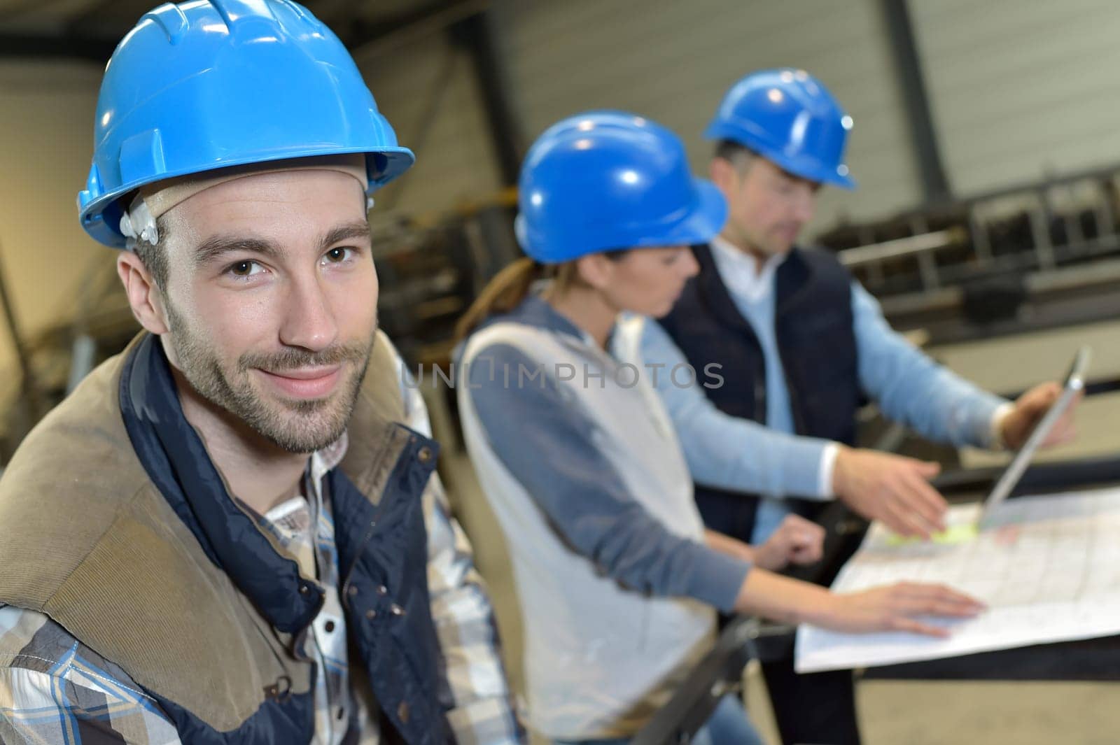 Portrait of cheerful industrial engineer