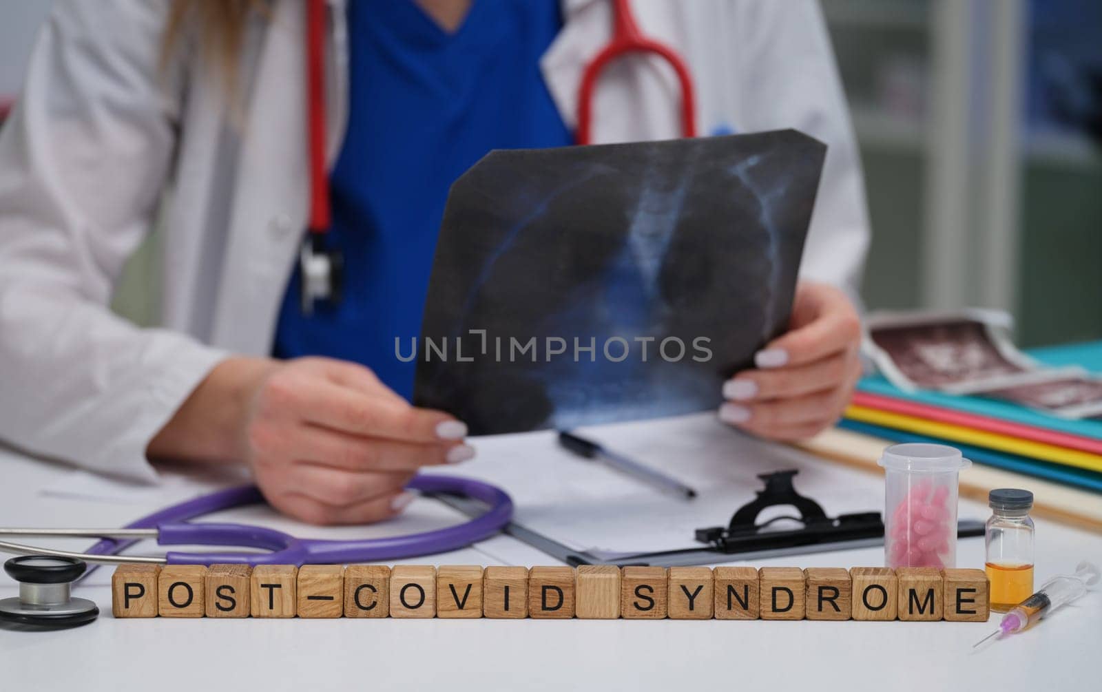 A healthcare professional is meticulously analyzing an Xray that is related to postCOVID syndrome observations