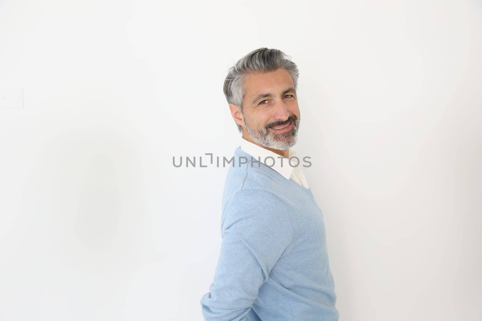 Handsome mature man standing on white background