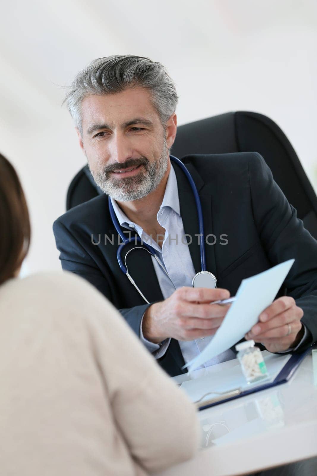 Doctor giving prescription to patient