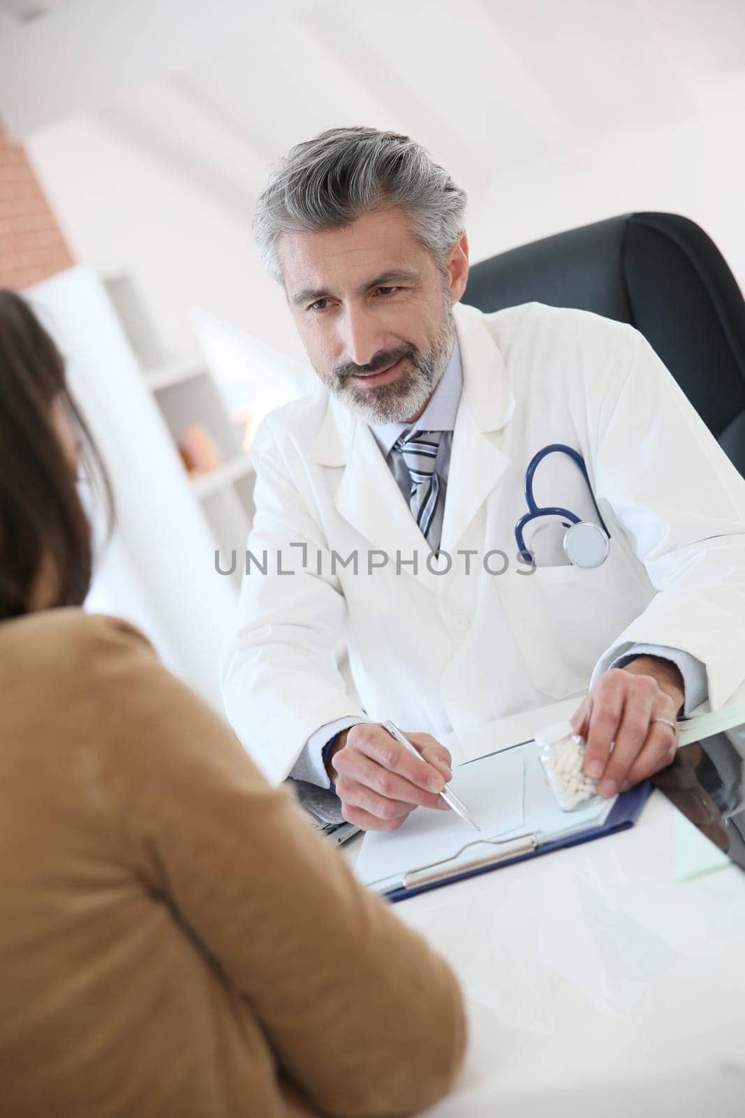 Doctor giving prescription to patient