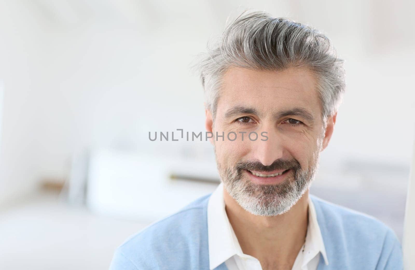 Portrait of handsome mature man with grey hair