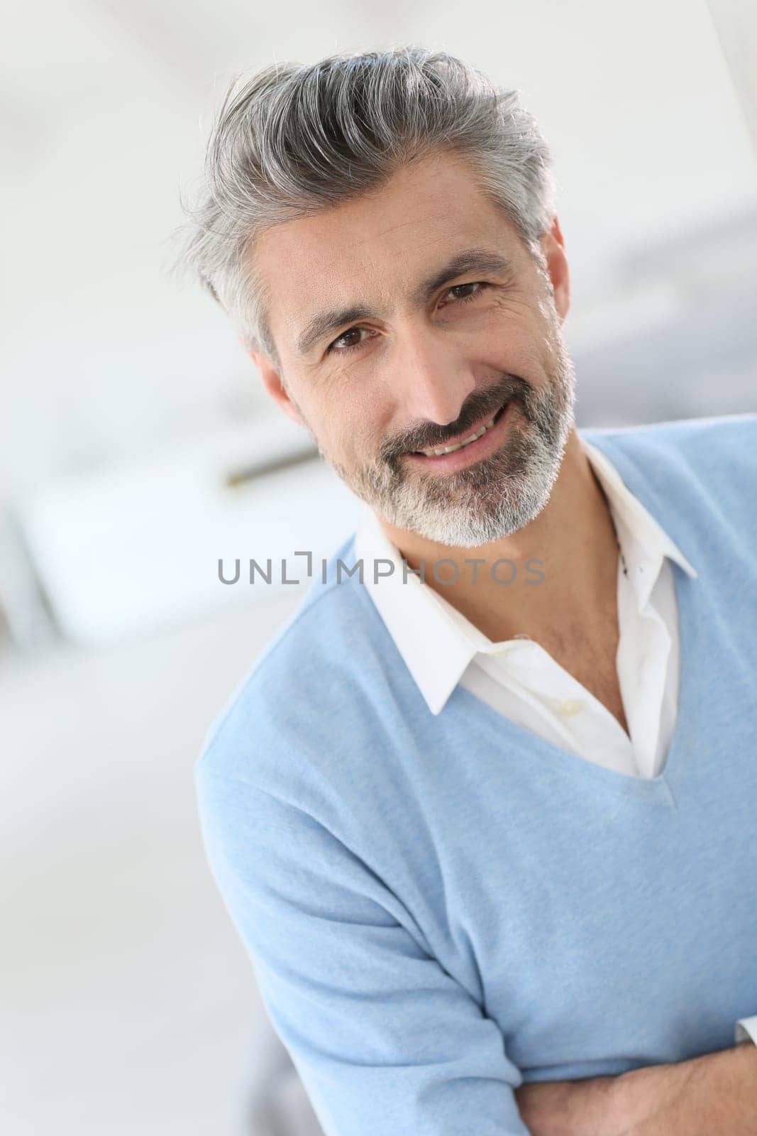 Portrait of handsome mature man with grey hair