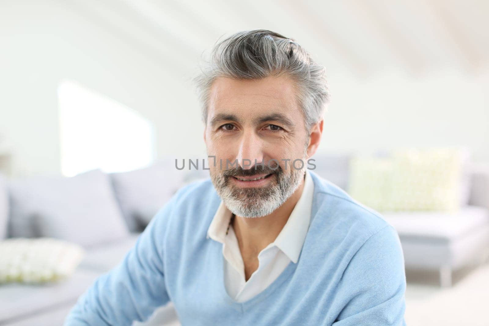 Portrait of handsome mature man with grey hair
