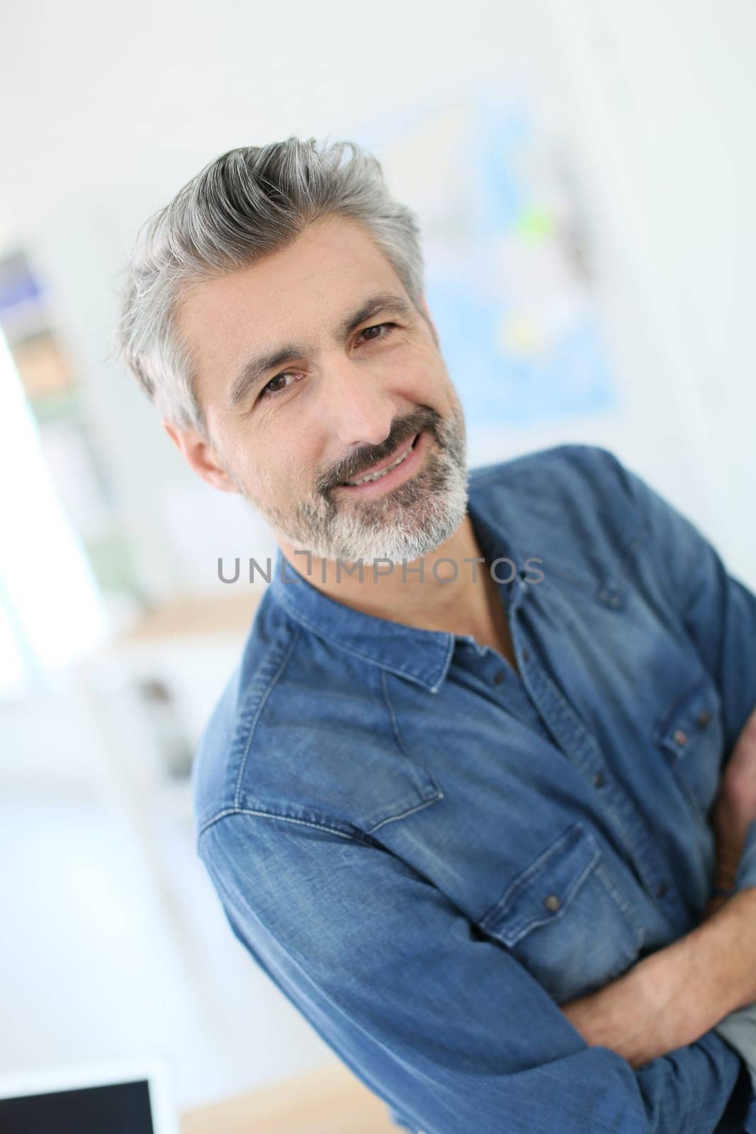 Portrait of smiling mature teacher in class