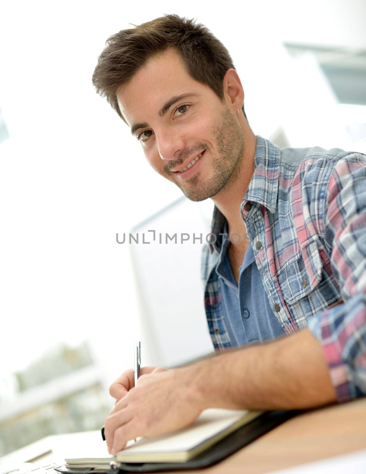 Smiling office worker sitting at desk