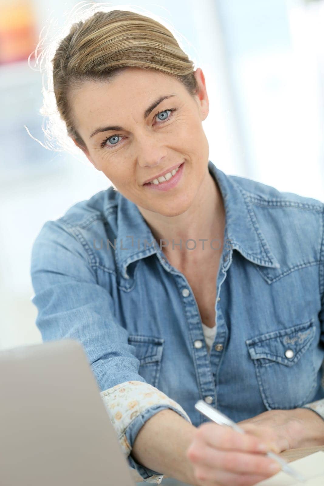 Businesswoman working from home on laptop