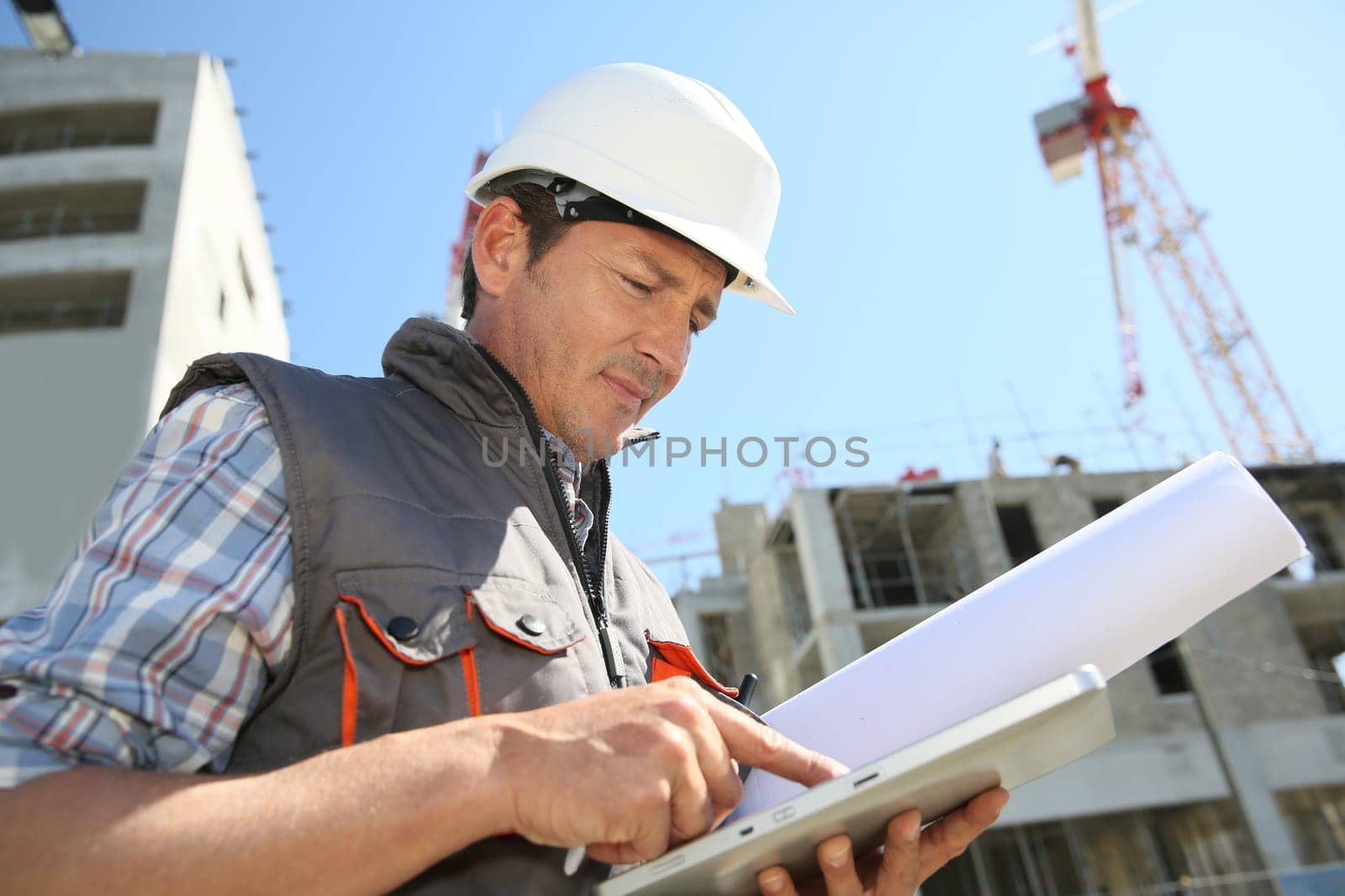 Entrepreneur on building site using tablet