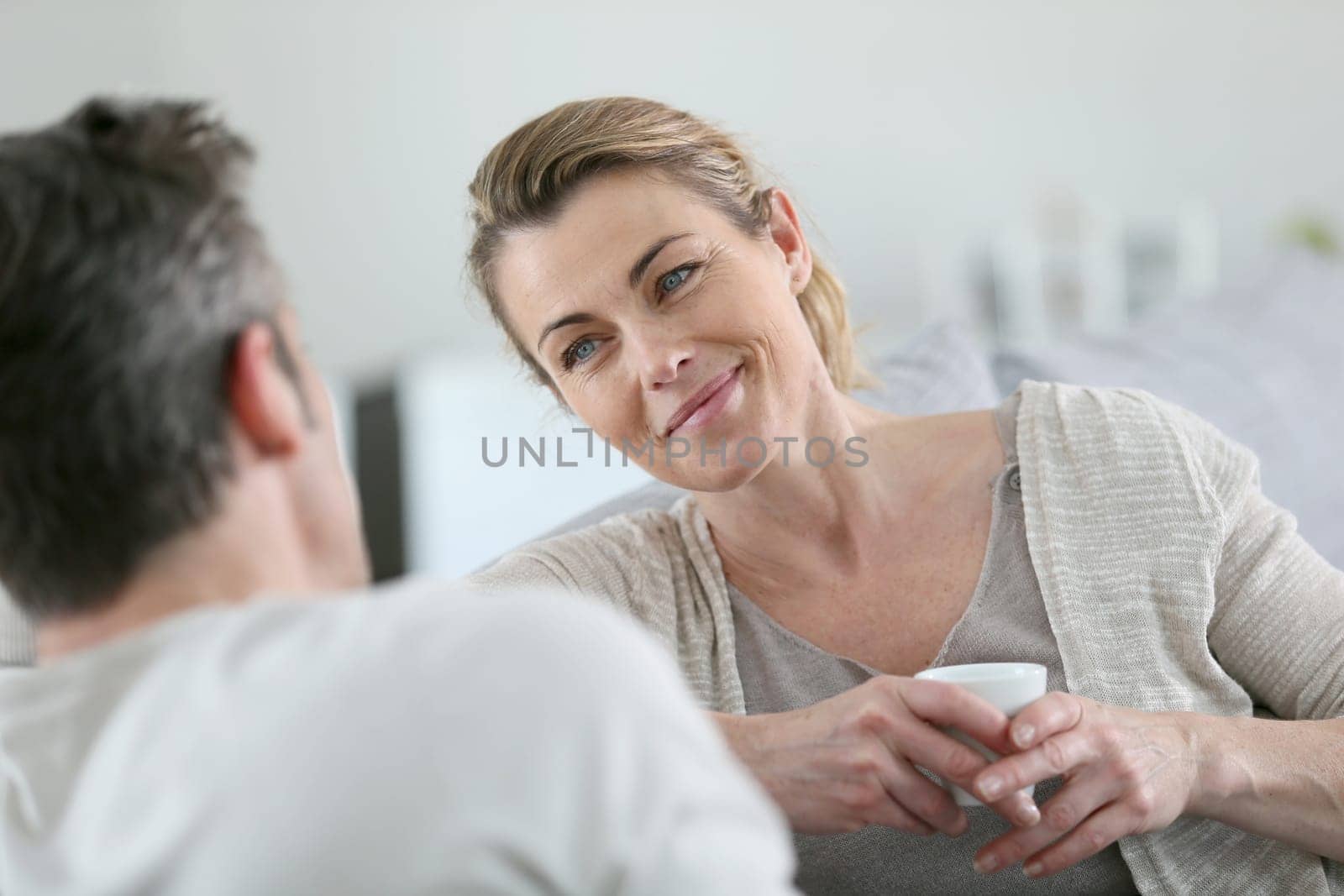 Mature couple talking together in sofa