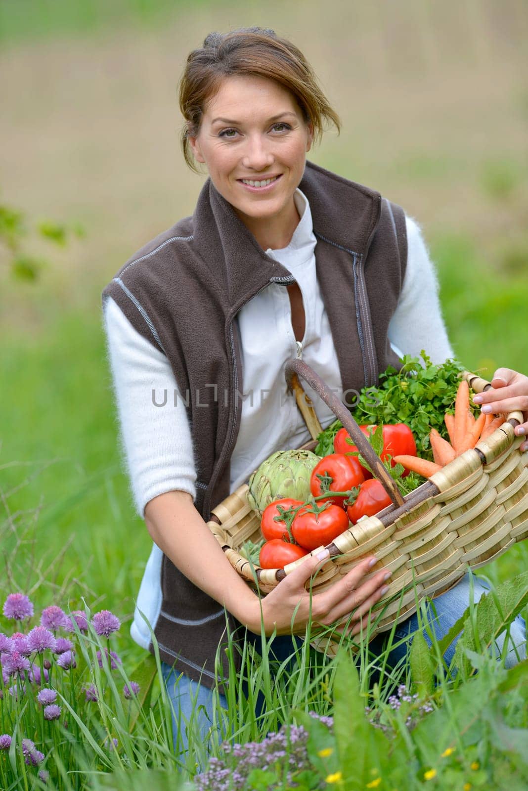 Beautiful woman holding basket of vegetables