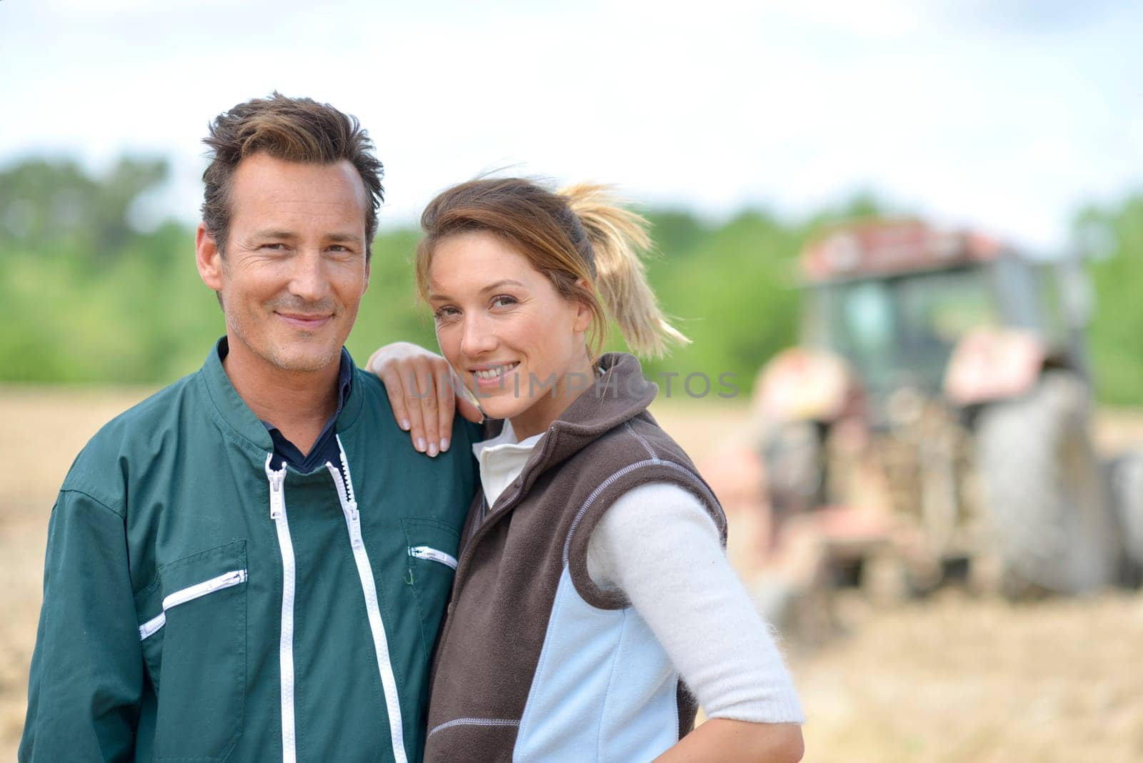 Couple of farmers standing in farming land