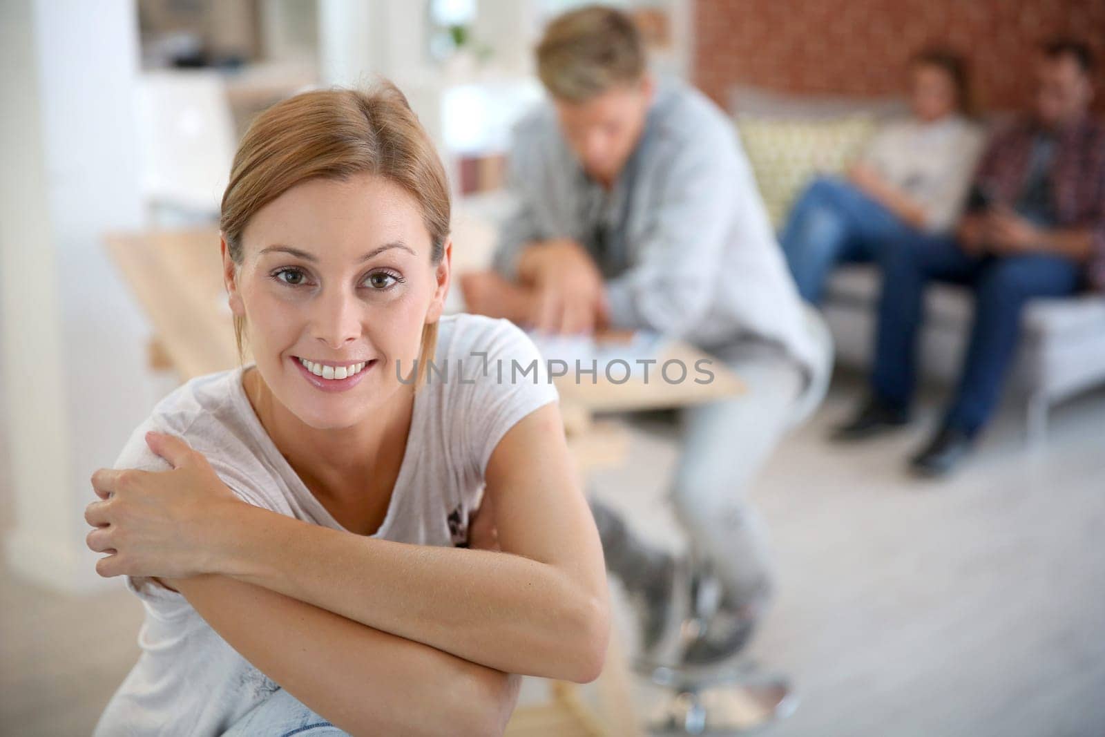 Smiling woman sitting in shared apartment