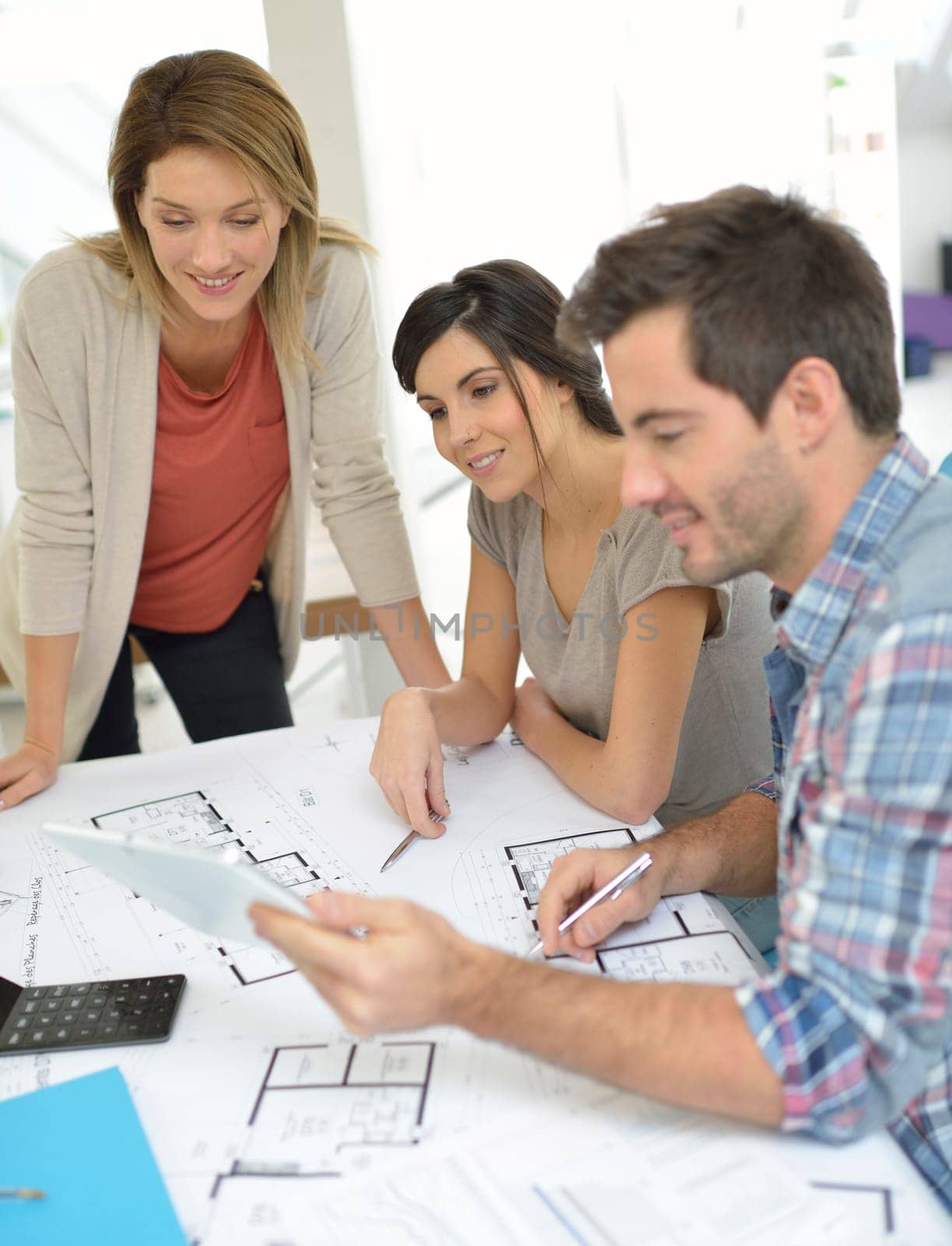 Workteam of architects meeting in office