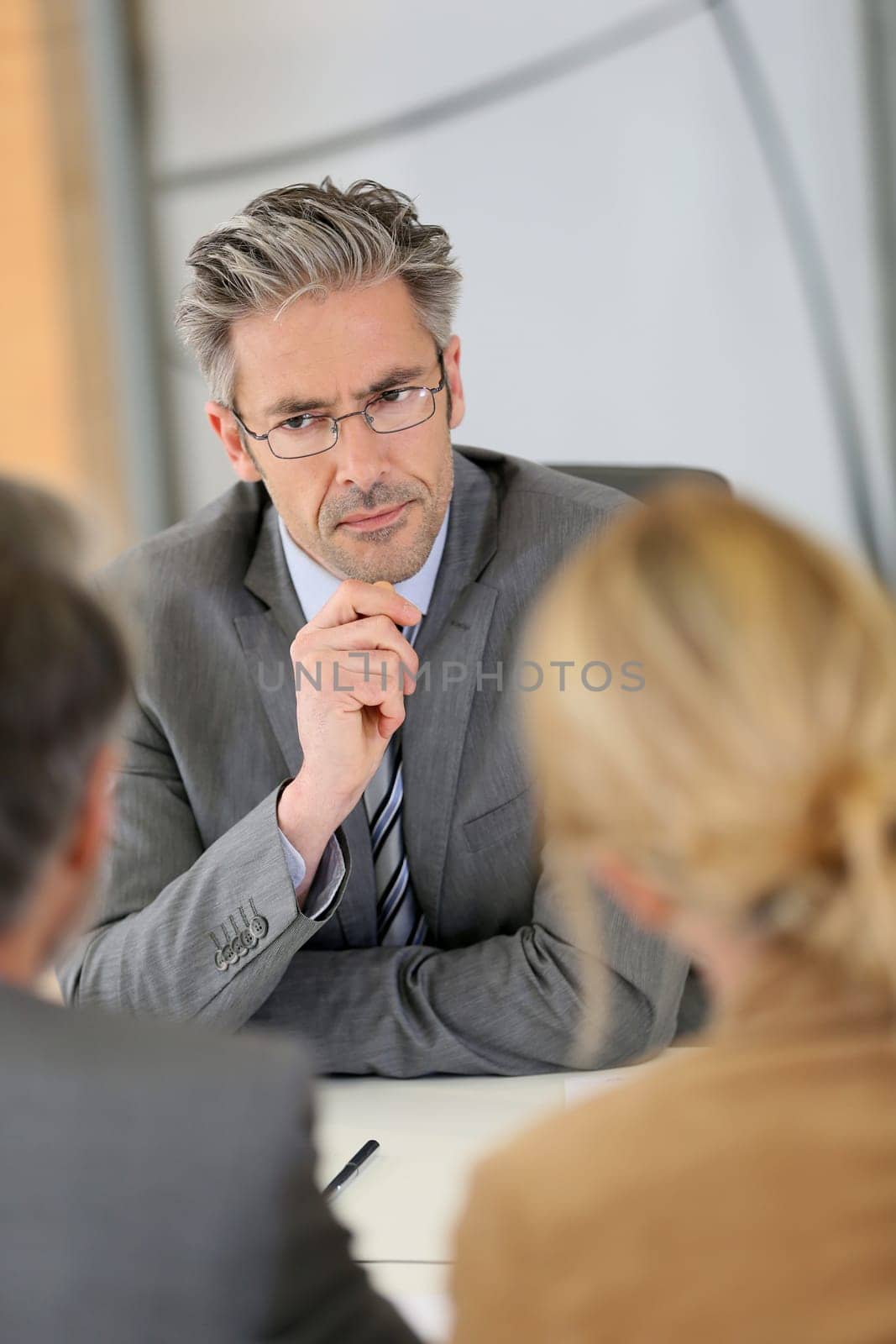 Consultant listening to clients in meeting