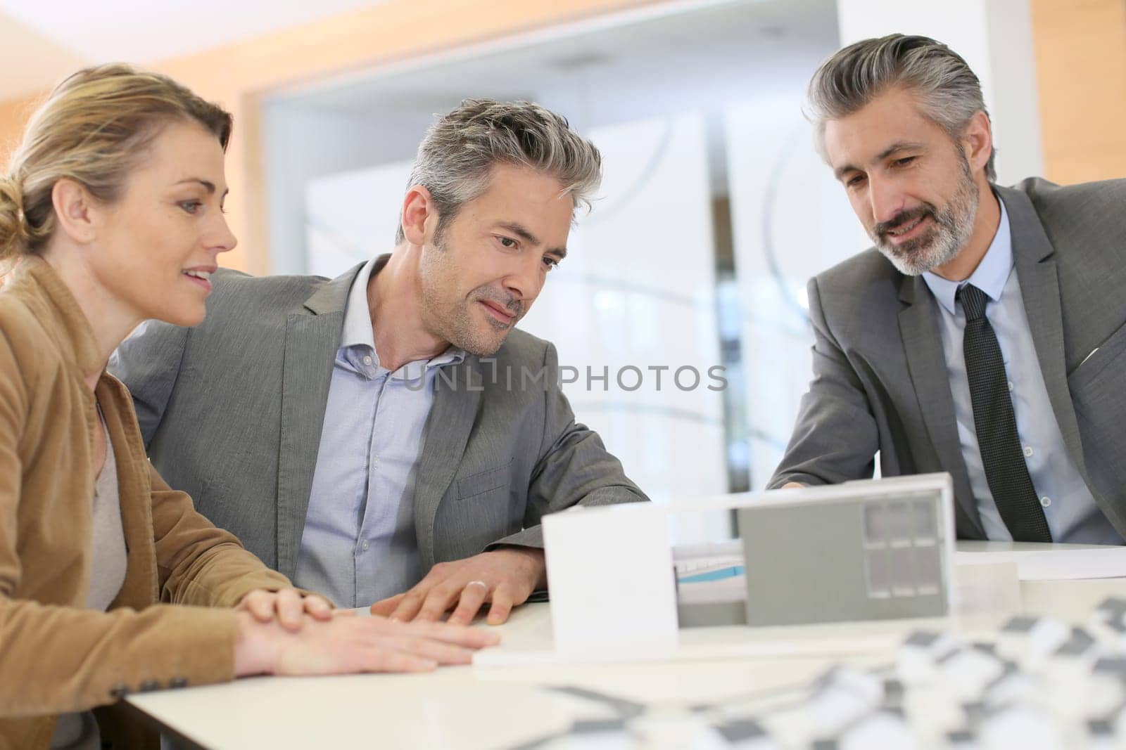 Mature couple meeting architect for construction project