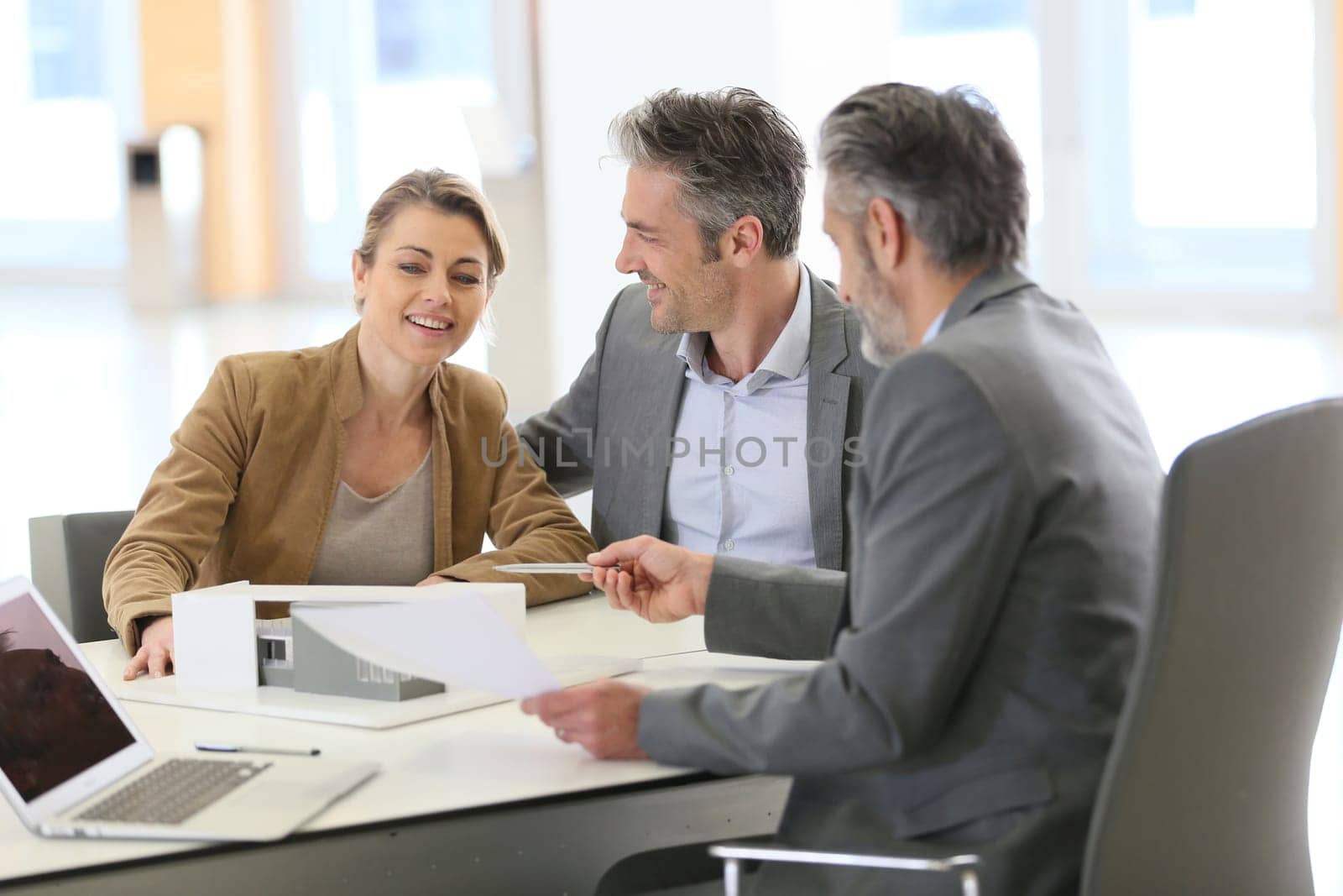 Mature couple meeting architect for construction project
