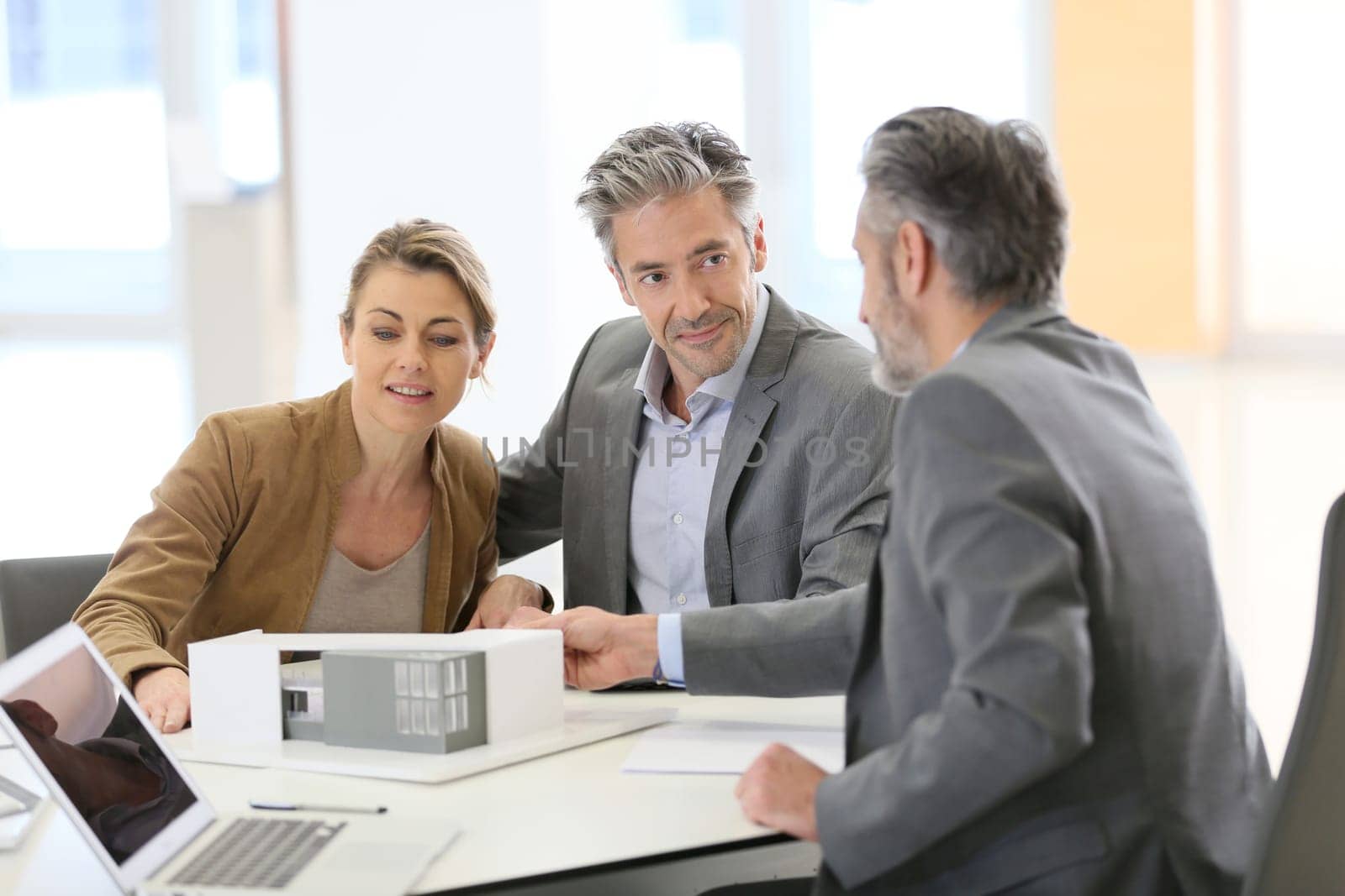 Mature couple meeting architect for construction project