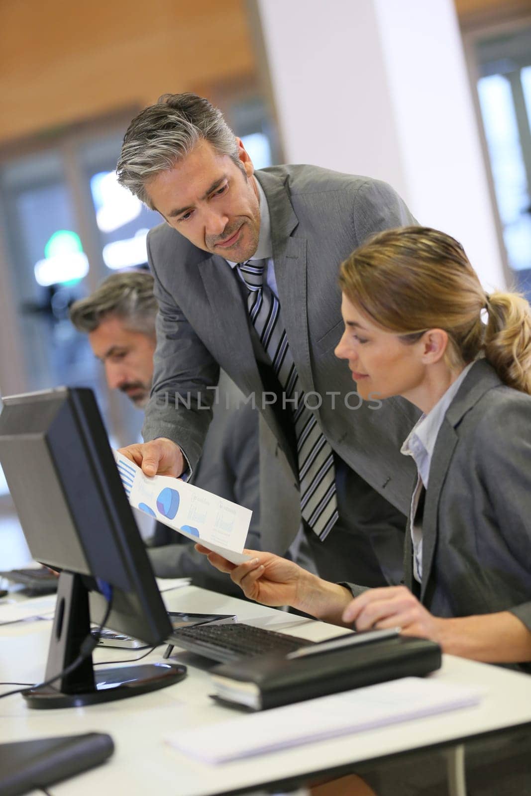 Business people working in office on desktop computer