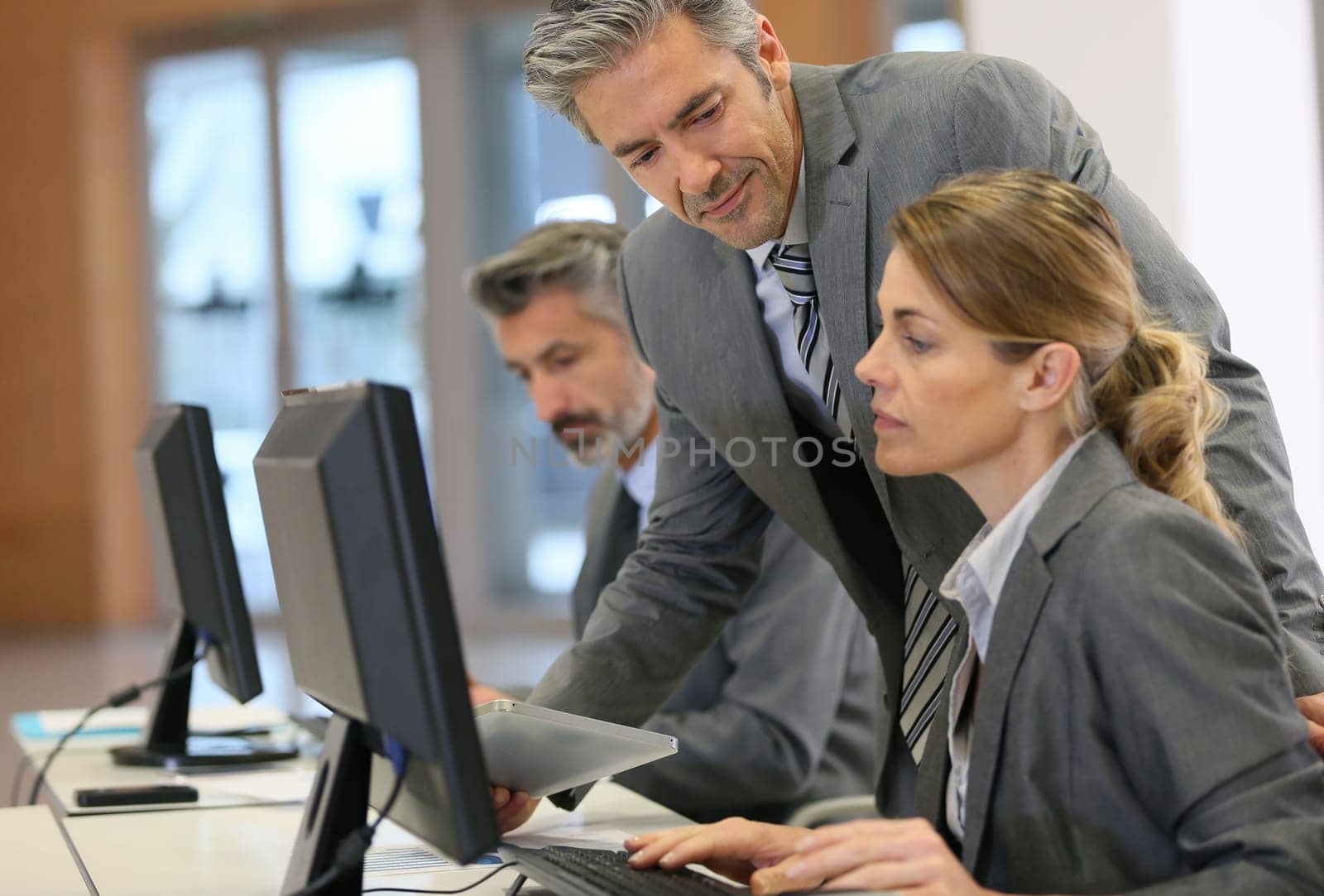 Business people working in office on desktop computer