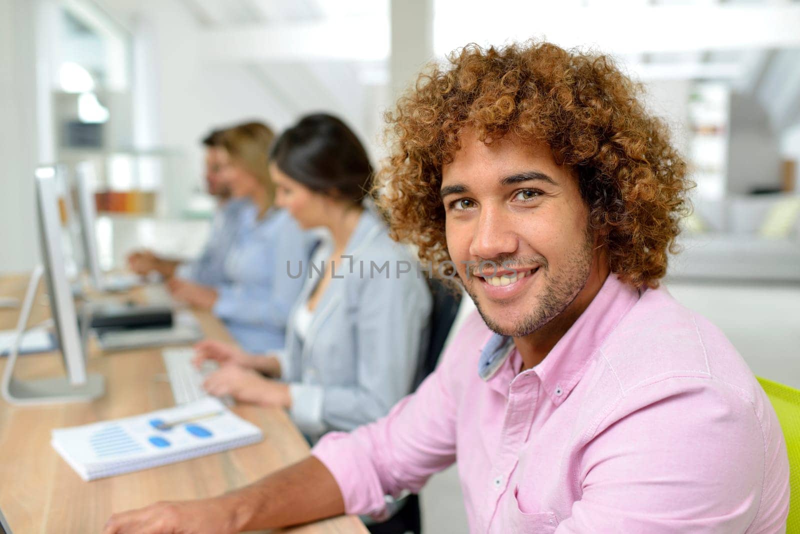 Young businessman in office working on laptop