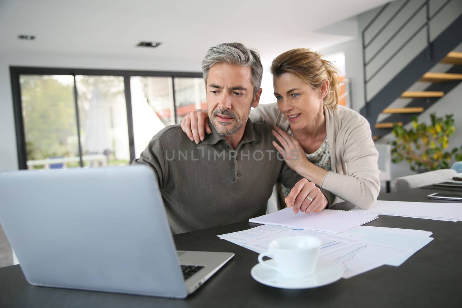Couple calculating financial savings on internet