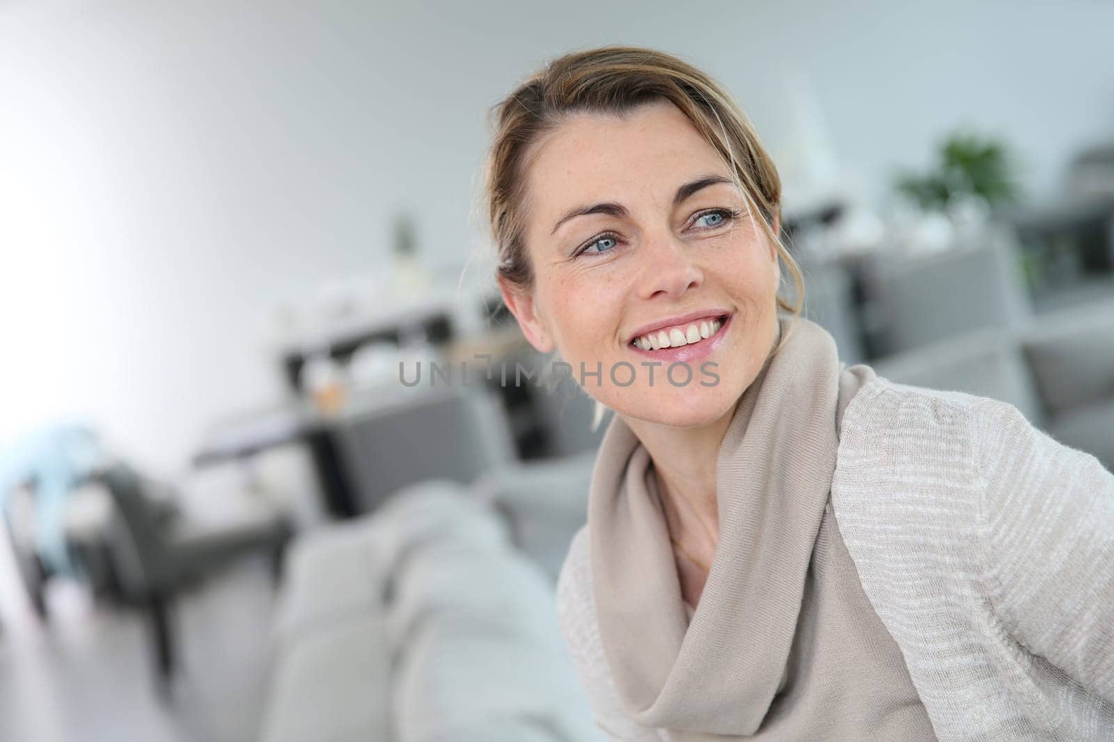 Portrait of middle-aged blond woman at home