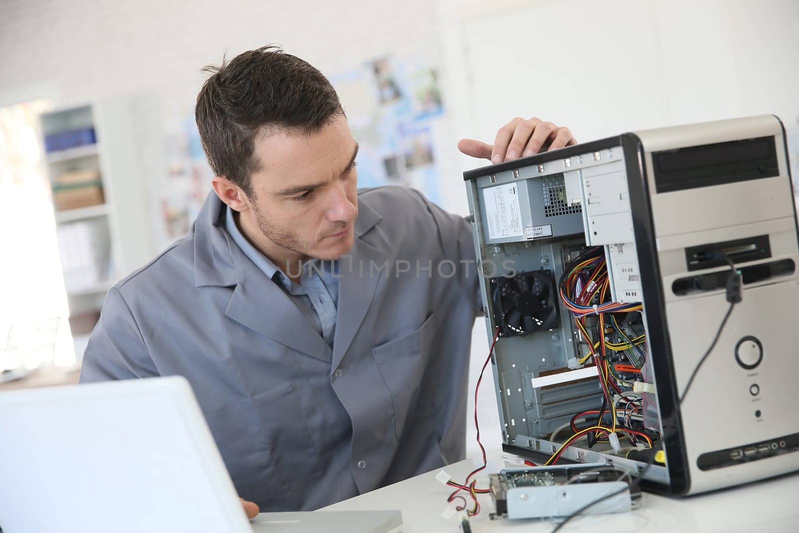 Technician fixing computer hardware