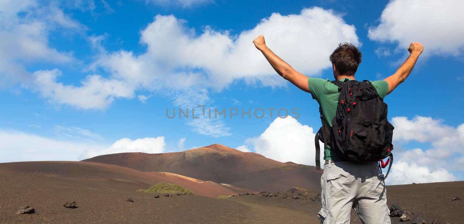Man can see the peak of volcano, nearly made it to top. Concept of success. Made it. Cloce to reaching the goal.