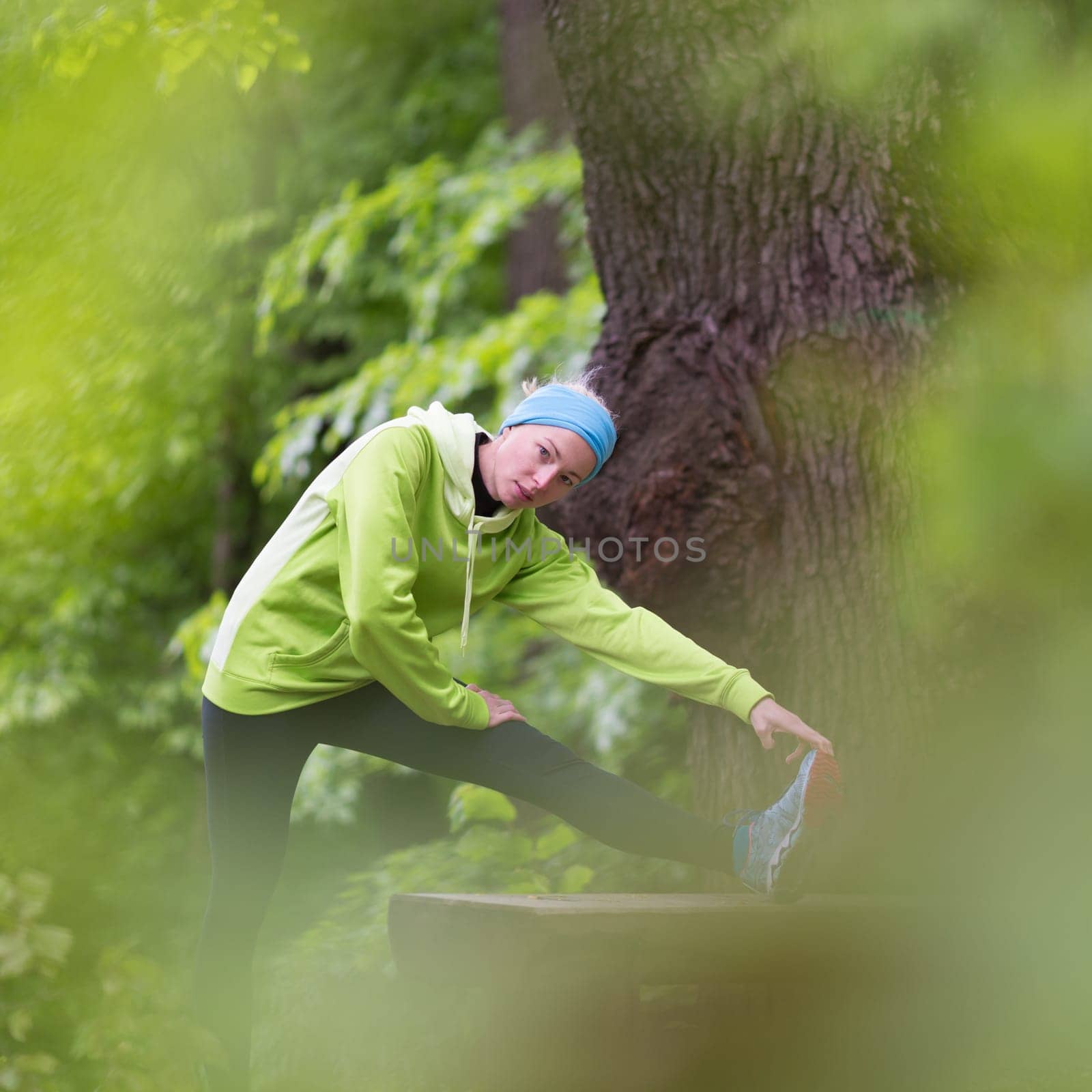 Sporty young female working out in forest.  Female runner during outdoor workout in nature. Fitness model outdoors. Weight Loss. Healthy lifestyle.