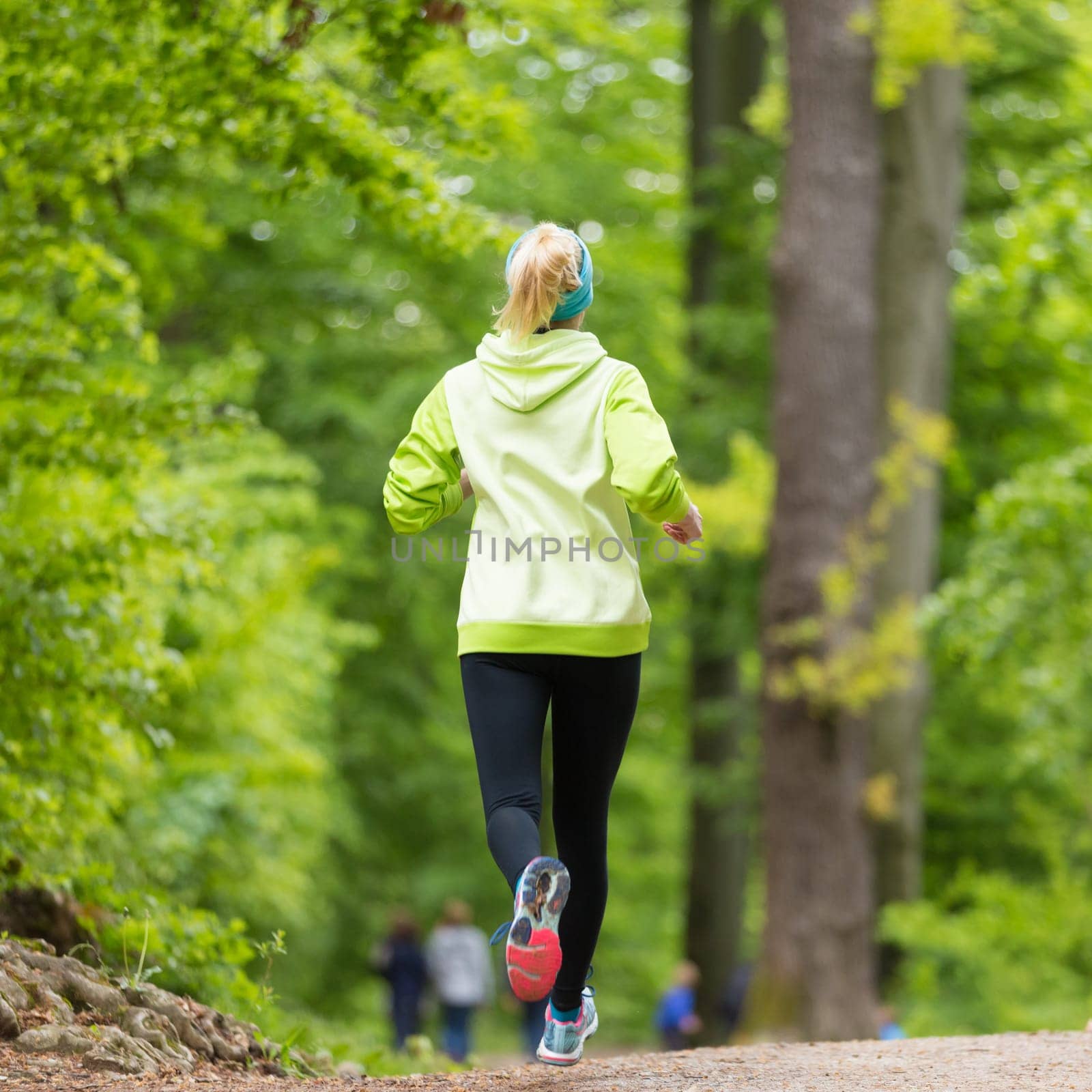 Sporty young female runner in forest.  Running woman. Female runner during outdoor workout in nature. Fitness model outdoors. Weight Loss. Healthy lifestyle.