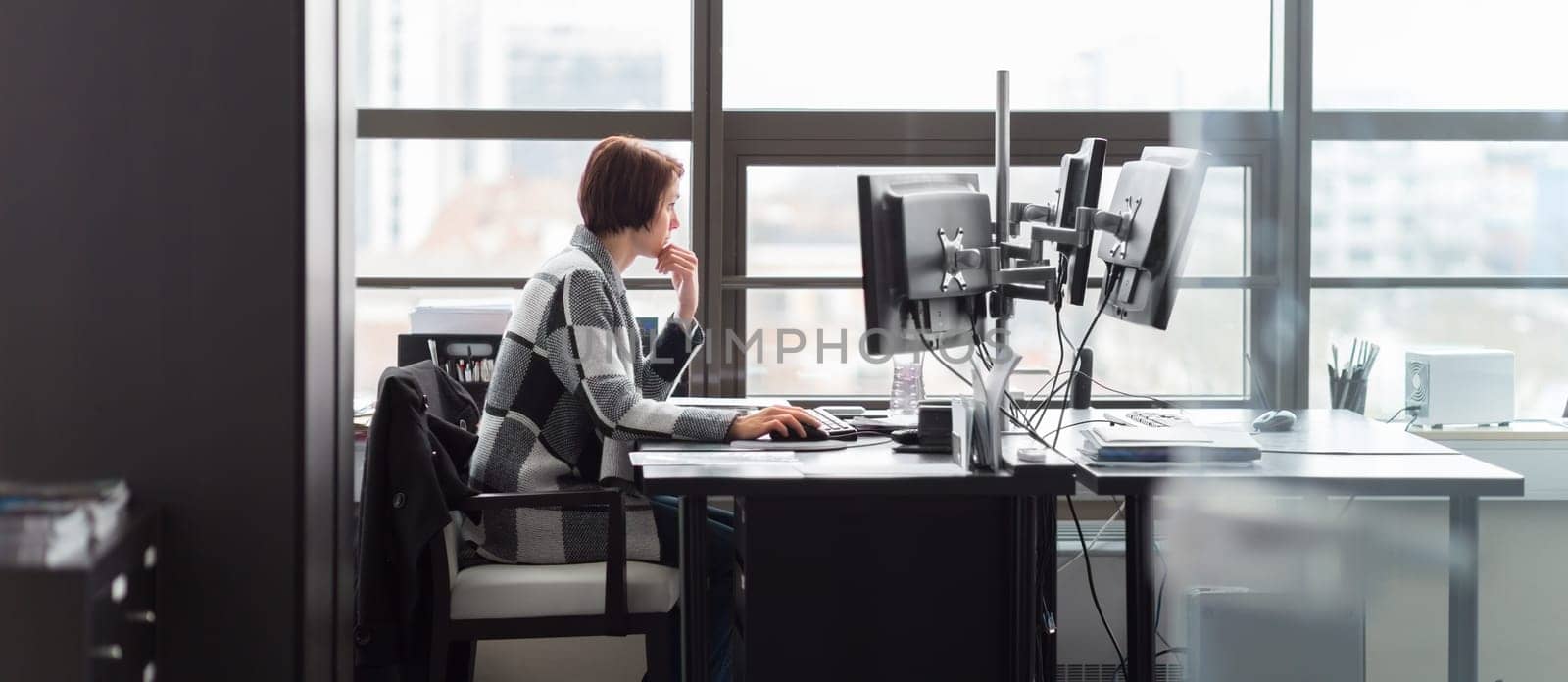 Confident independent business woman working in corporate office. Female equality in business and entrepreneurship concept.